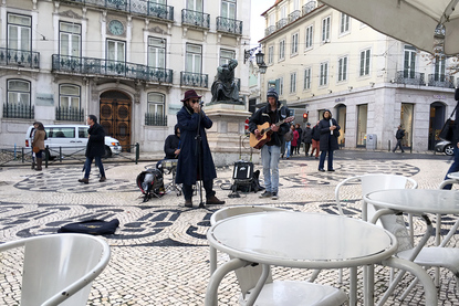Musicians - Street performers busk outside of Café a Brasileira on Rua Garrett, Lisbon, Portugal.