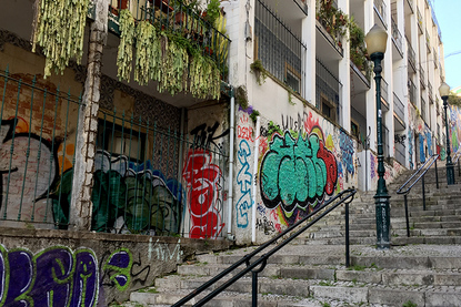 Graffiti covered homes and stairway on Calcada do Lavra, Lisbon, Portugal - Calçada do Lavra street art.