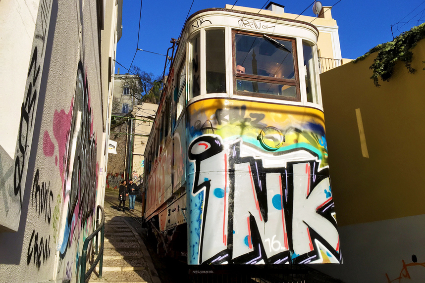 Graffiti covered Ascensor do Lavra tram on Calcada do Lavra, Lisbon, Portugal - Calçada do Lavra street art.