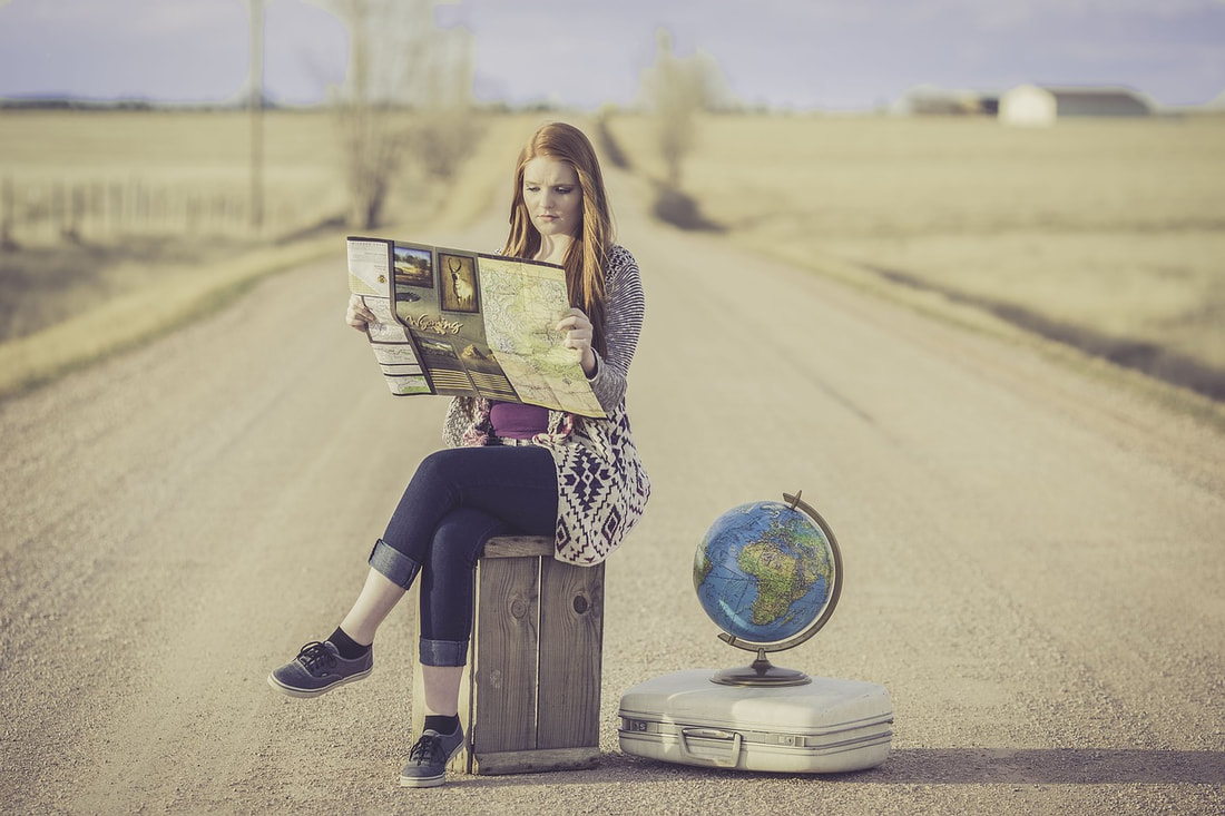All you need to do before you study abroad in Australia. Country girl looking at map.
