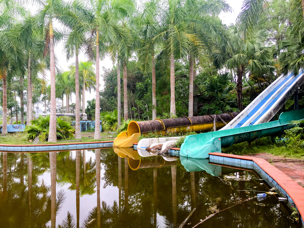 The brown murky algae water that fills the water slide swimming pools // Hue: Ho Thuy Tien, Photos of Vietnam's Abandoned Water Park.