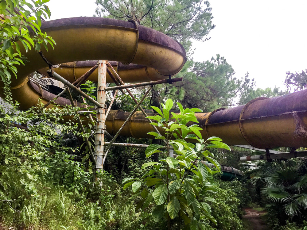 Walking through the overgrown garden and underneath the large water slides // Hue: Ho Thuy Tien, Photos of Vietnam's Abandoned Water Park.