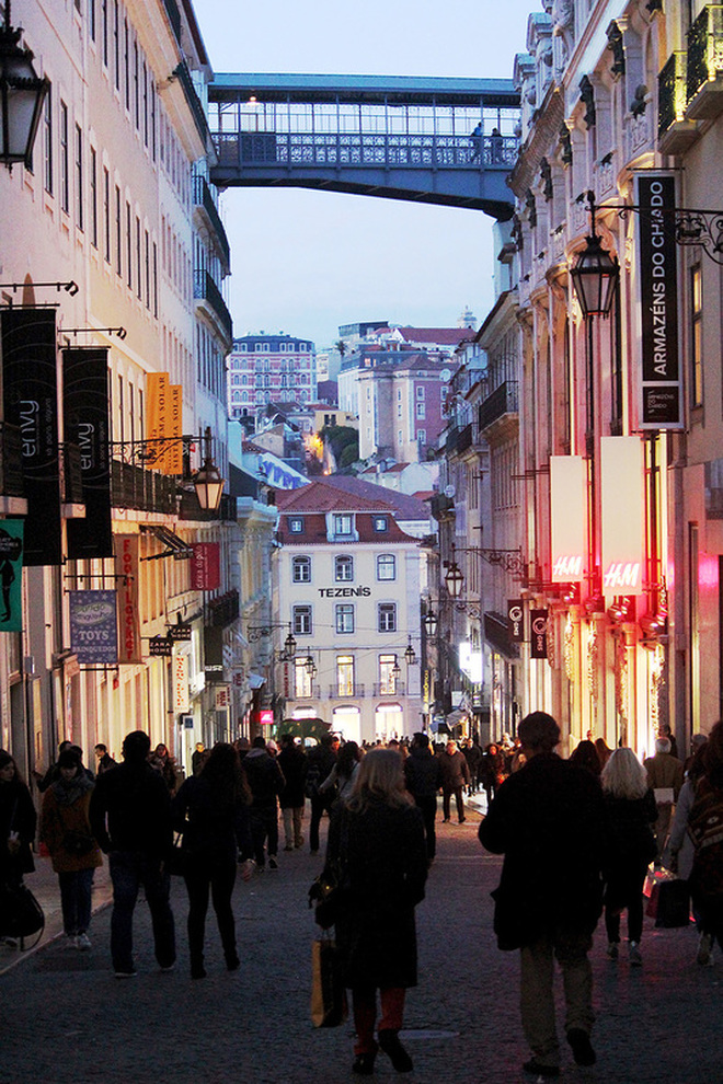 People shopping in the busy Baixa-Chiado district at dusk - Lisbon - Portugal.