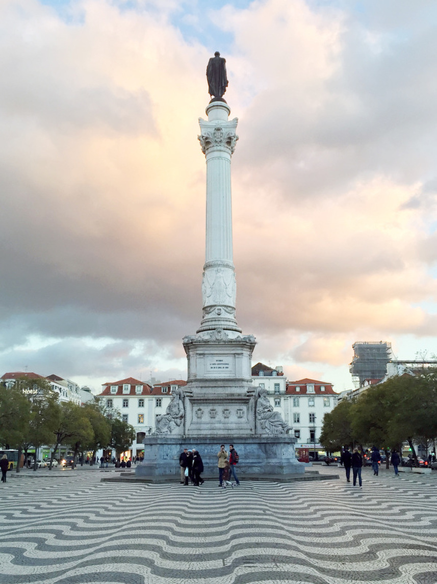 The Column of Pedro IV and Portuguese pattern pavement in Pedro IV/ Rossio Square, Lisbon, Portugal.