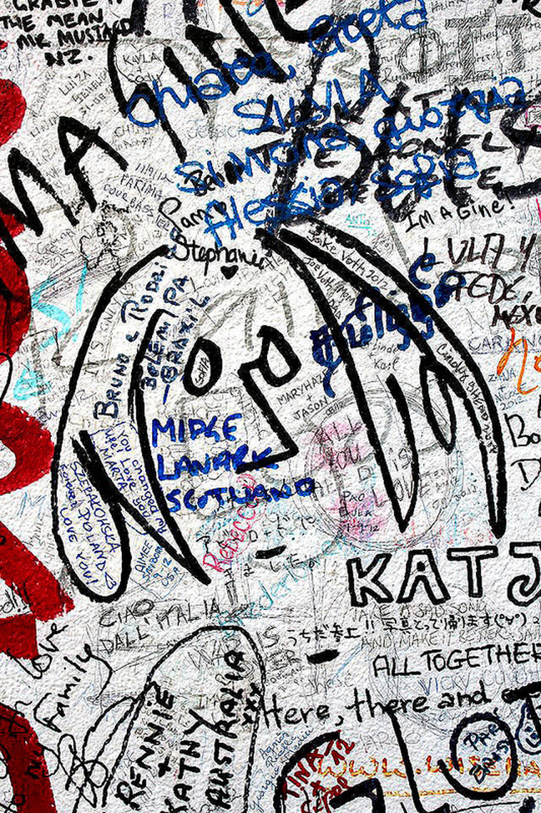 Fan drawn John Lennon graffiti adorning the fence of Abbey Road Studios - Abbey Road Crossing, London, England - Tily Travels.