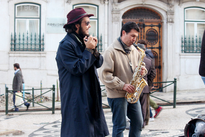 Musicians - Street performers busk outside of Café a Brasileira on Rua Garrett, Lisbon, Portugal.