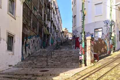 Graffiti covered stairway and alley on Calcada do Lavra, Lisbon, Portugal - Calçada do Lavra street art.