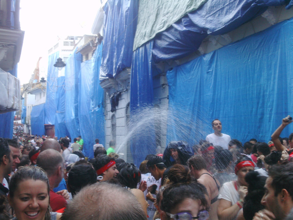 Hoses drenching festival goers before La Tomatina 2013