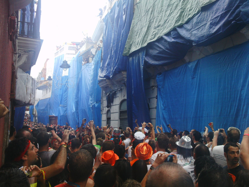 The crowd cheering as the signal sounded, beginning the start La Tomatina 2013