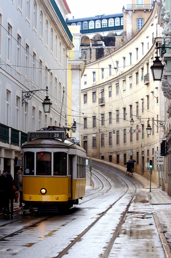 Lisbon's famous Number 28 tram stopping to pick up passengers on Rua da Conceição - Pombaline-Baixa, Lisbon - Portugal.
