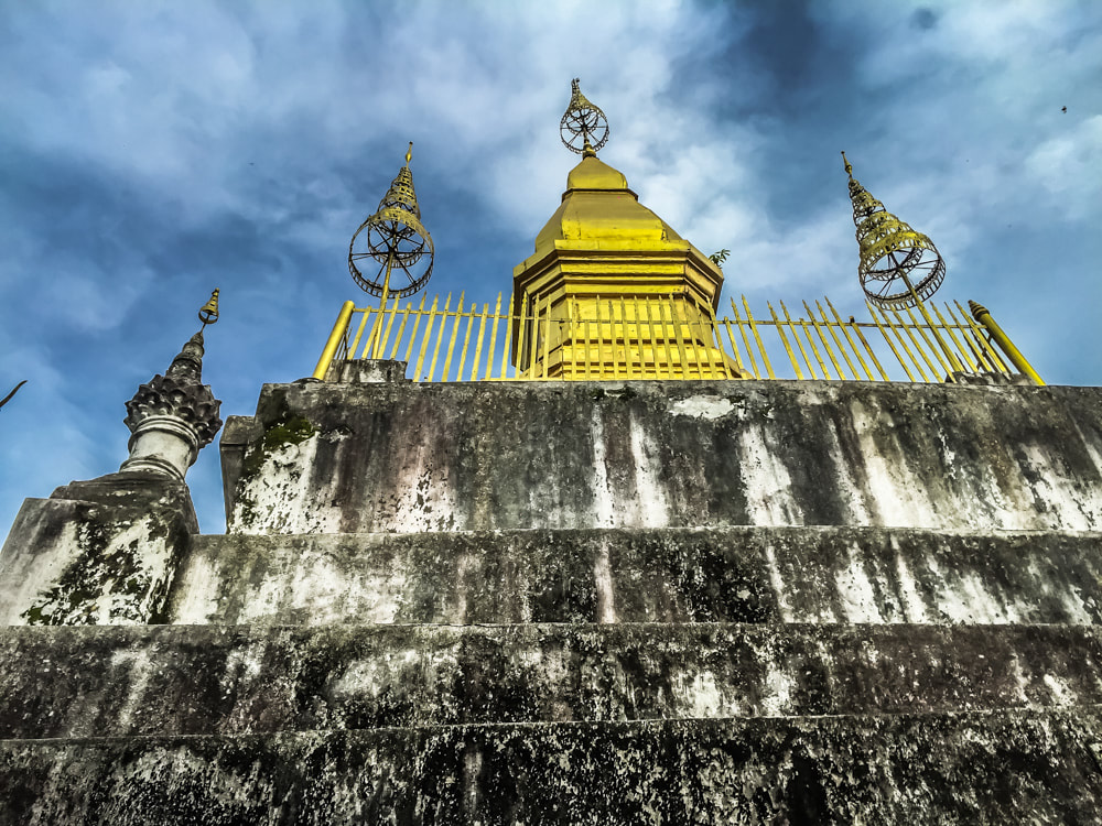 The gilded stupa of Wat Chom Si on the summit of Mount Phousi. Luang Prabang, Laos.