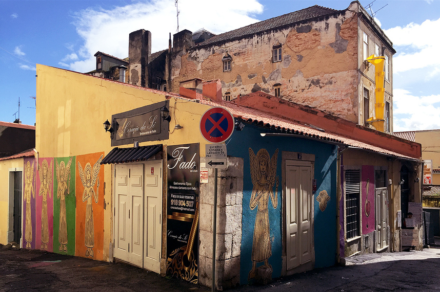 Alfama district - Street art in Lisbon's Old Quarter, Purple, pink, green, orange and blue Lisbon Angels on the walls of Club Fado (Clube de Fado).