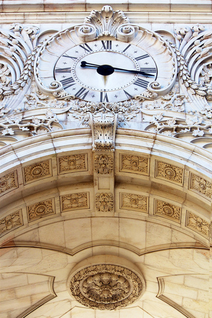 Looking up at the clock on the Rua Augusta Arch, Lisbon, Portugal.