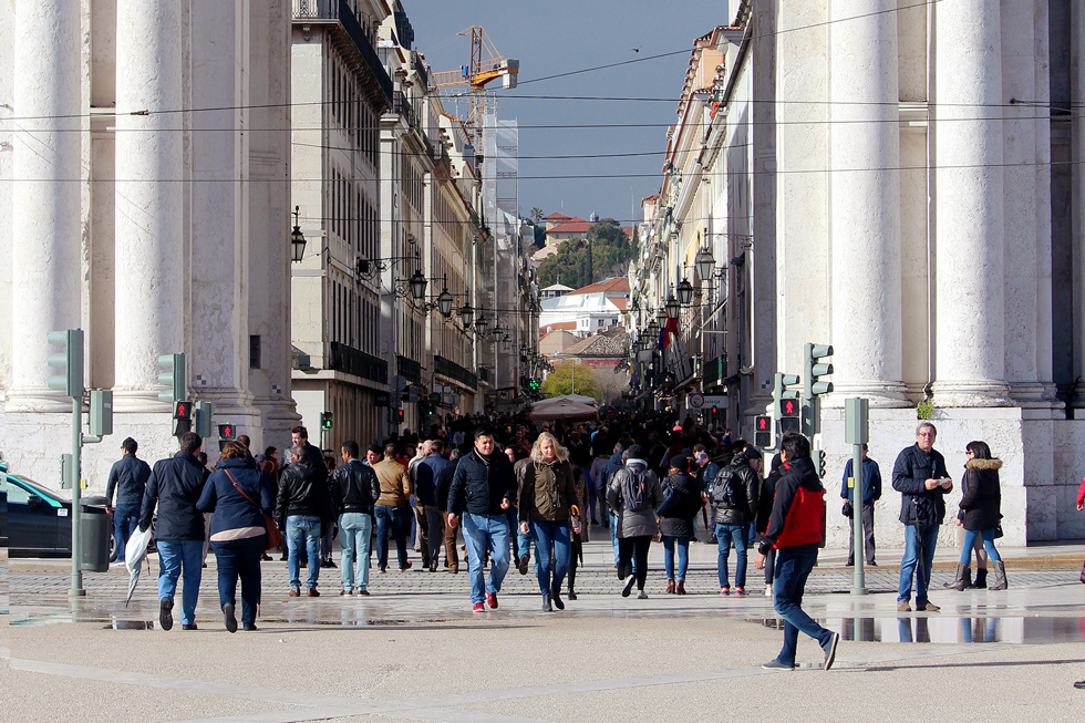 People walking under the Rua Augusta Arch, Praca do Comercio, Lisbon, Portugal.