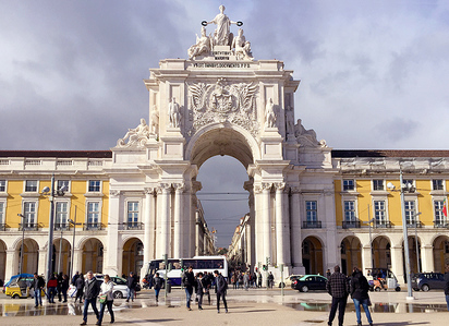 Traditional yellow portuguese architecture and the Rua Augusta Arch, Praca do Comercio market, Lisbon, Portugal.