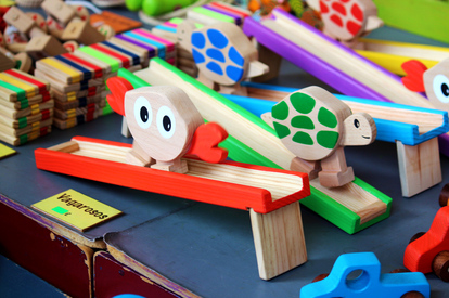 Close up of colourful wooden children's toys (crab and turtle) at the Praca do Comercio handicraft market, Lisbon, Portugal.