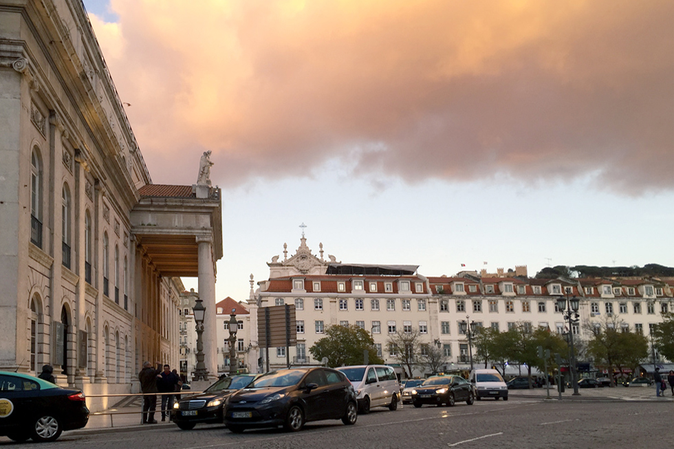 Clouds (reminiscent of smoke from a fire), billow over the National Theatre D.Maria II and Pedro IV/ Rossio square at dusk, Lisbon, Portugal.